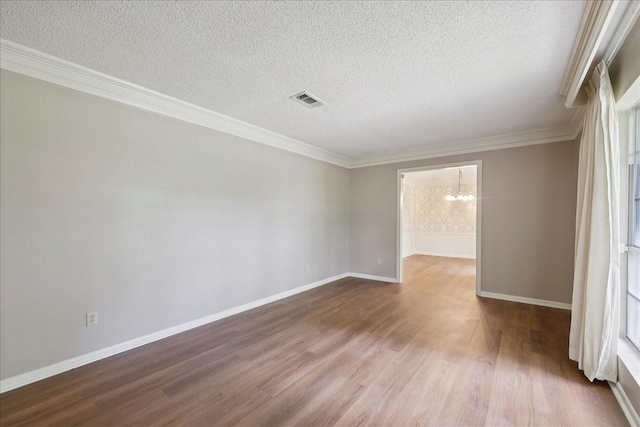 5210 Linda Ln, Beaumont, TX 77708 - empty room with wood finished floors, a textured ceiling, healthy amount of natural light, baseboards, and crown molding