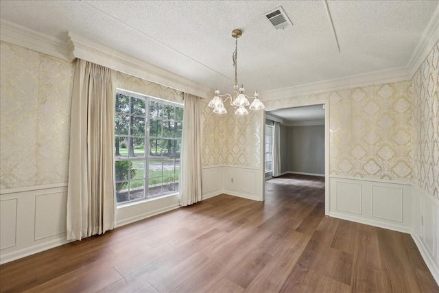 5210 Linda Ln, Beaumont, TX 77708 - unfurnished dining area featuring wallpapered walls, a chandelier, ornamental molding, dark wood-style flooring, and a textured ceiling