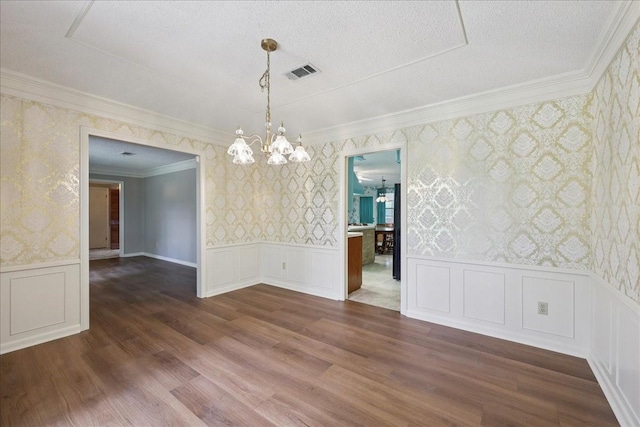 5210 Linda Ln, Beaumont, TX 77708 - empty room with wallpapered walls, a chandelier, ornamental molding, a wainscoted wall, and a decorative wall