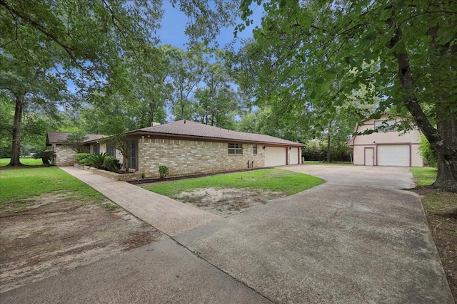 5210 Linda Ln, Beaumont, TX 77708 - view of home's exterior featuring brick siding, a yard, and an attached garage