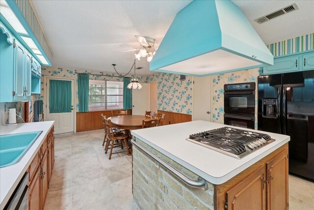 5210 Linda Ln, Beaumont, TX 77708 - kitchen featuring black appliances, wallpapered walls, light countertops, a sink, and a chandelier