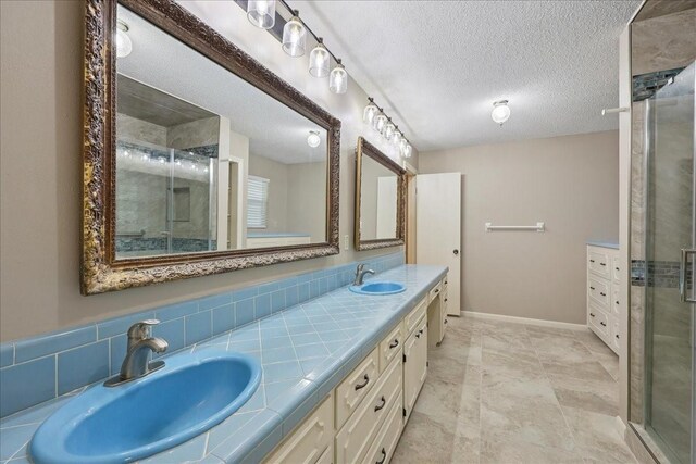 5210 Linda Ln, Beaumont, TX 77708 - full bath featuring double vanity, a stall shower, a textured ceiling, and baseboards