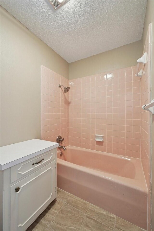 5210 Linda Ln, Beaumont, TX 77708 - full bathroom with shower / washtub combination, a textured ceiling, and vanity