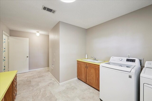 5210 Linda Ln, Beaumont, TX 77708 - washroom featuring washer and clothes dryer, cabinet space, and baseboards
