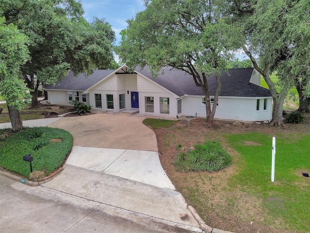 2702 Fairway Dr, Sugar Land, TX 77478 - mid-century home with concrete driveway, a front yard, and roof with shingles
