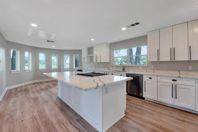 2702 Fairway Dr, Sugar Land, TX 77478 - kitchen featuring dishwasher, a sink, a center island, white cabinetry, and light wood-type flooring
