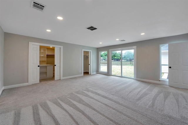 2702 Fairway Dr, Sugar Land, TX 77478 - unfurnished bedroom with light colored carpet, baseboards, a walk in closet, and recessed lighting