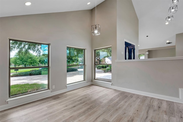 2702 Fairway Dr, Sugar Land, TX 77478 - unfurnished living room with high vaulted ceiling, baseboards, and wood finished floors