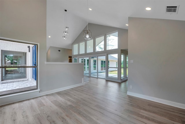 2702 Fairway Dr, Sugar Land, TX 77478 - unfurnished living room with high vaulted ceiling, wood finished floors, baseboards, and recessed lighting