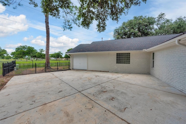 2702 Fairway Dr, Sugar Land, TX 77478 - view of side of home with a garage, driveway, brick siding, and a shingled roof