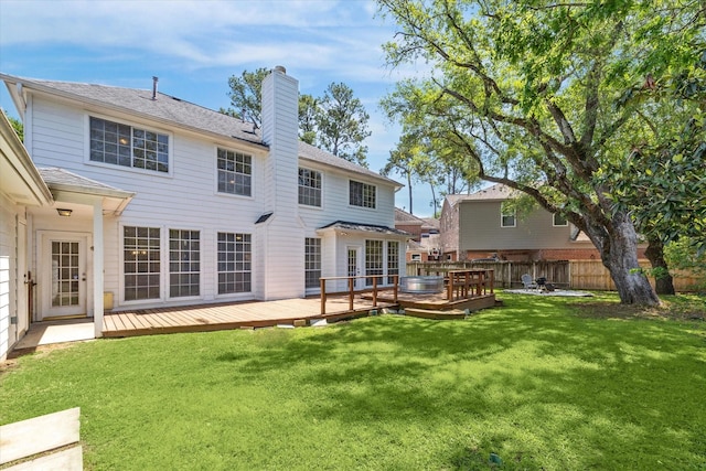7930 Tizerton Ct, Spring, TX 77379 - rear view of house featuring a chimney and a wooden deck