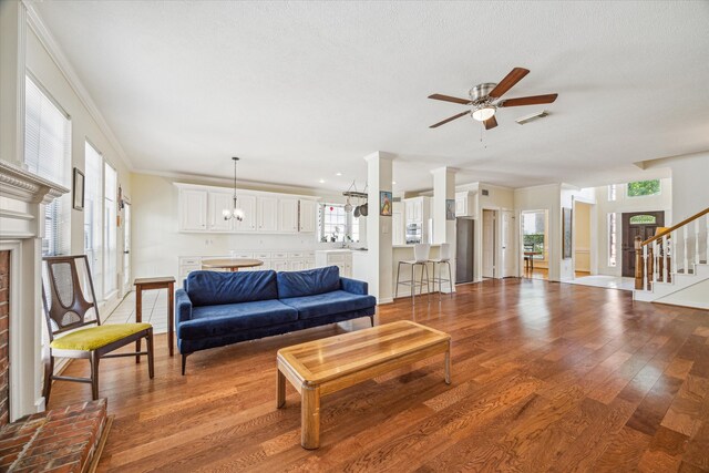 7930 Tizerton Ct, Spring, TX 77379 - living area featuring a ceiling fan, wood finished floors, stairway, baseboards, and crown molding