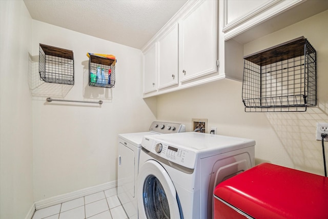 7930 Tizerton Ct, Spring, TX 77379 - laundry area with washer and clothes dryer, baseboards, cabinet space, and light tile patterned floors