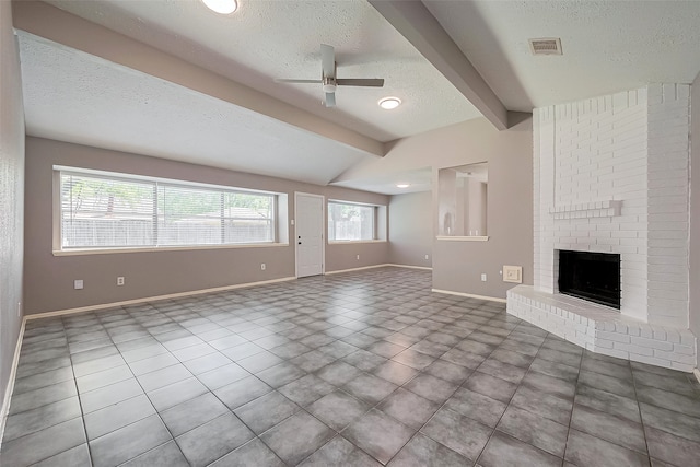 24226 Spring Towne Dr, Spring, TX 77373 - unfurnished living room featuring a textured ceiling, ceiling fan, baseboards, a fireplace, and tile patterned flooring