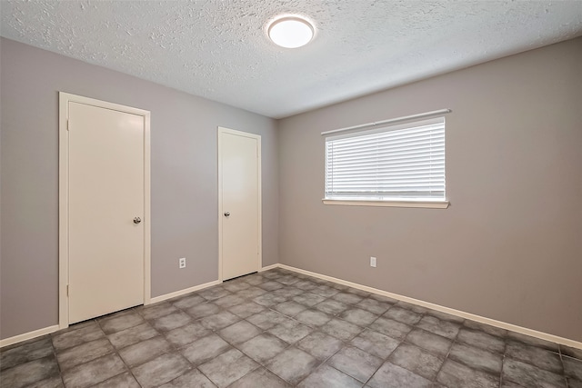 24226 Spring Towne Dr, Spring, TX 77373 - unfurnished bedroom with a textured ceiling and baseboards