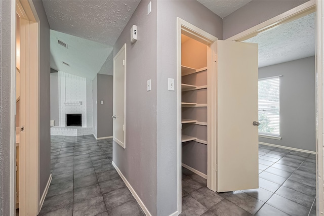 24226 Spring Towne Dr, Spring, TX 77373 - hall with a textured ceiling, baseboards, and tile patterned flooring
