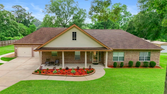 8518 Kerr Dr, Tomball, TX 77375 - view of front of house with driveway, covered porch, brick siding, a garage, and a shingled roof