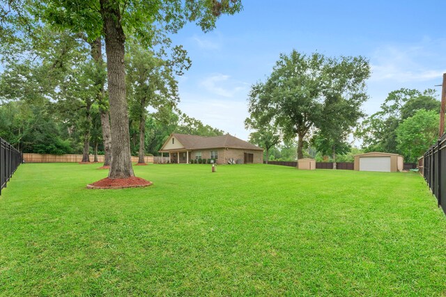 8518 Kerr Dr, Tomball, TX 77375 - view of yard featuring an outbuilding and a garage