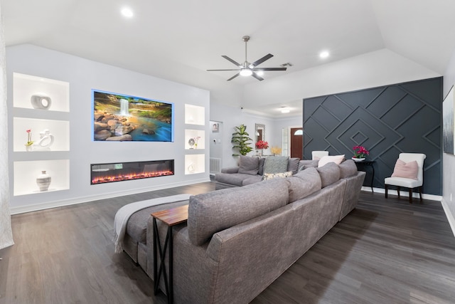 8518 Kerr Dr, Tomball, TX 77375 - living room featuring vaulted ceiling, built in features, ceiling fan, a glass covered fireplace, and wood finished floors
