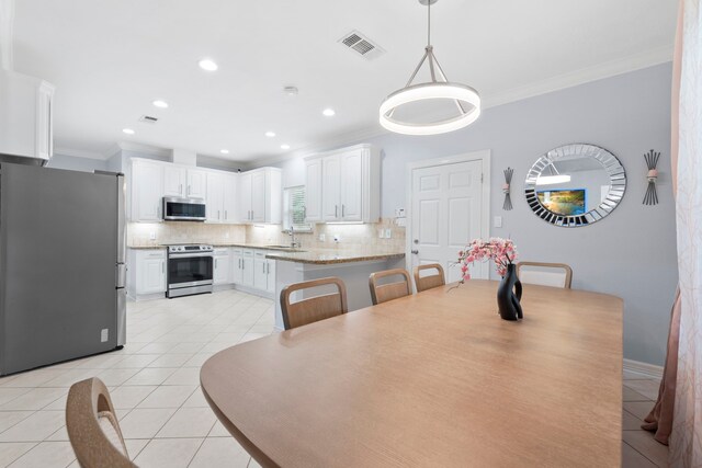 8518 Kerr Dr, Tomball, TX 77375 - dining space with light tile patterned floors, ornamental molding, and recessed lighting