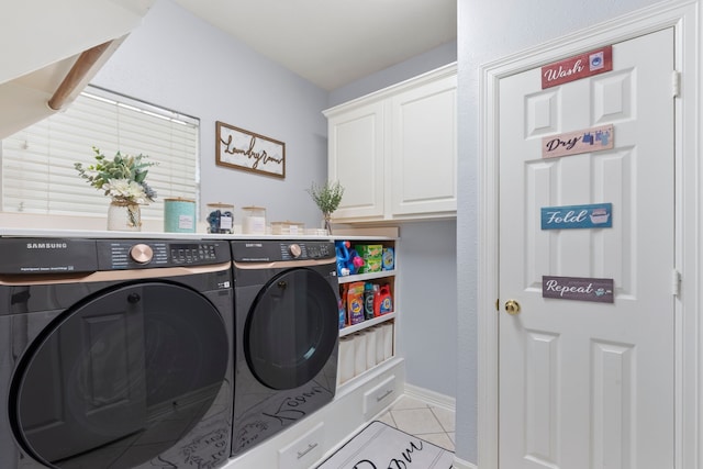 8518 Kerr Dr, Tomball, TX 77375 - laundry area with separate washer and dryer, light tile patterned floors, cabinet space, and baseboards