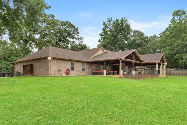 8518 Kerr Dr, Tomball, TX 77375 - rear view of house featuring central AC, a shingled roof, brick siding, and a patio area