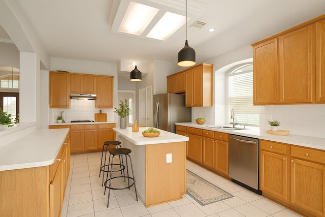 4903 Cedar Cove Dr, Baytown, TX 77521 - kitchen featuring appliances with stainless steel finishes, a sink, plenty of natural light, and a kitchen island