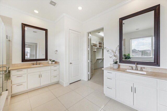 1318 Bobbitt Manor Ln, Houston, TX 77055 - bathroom featuring two vanities, ornamental molding, tile patterned flooring, a spacious closet, and a shower stall