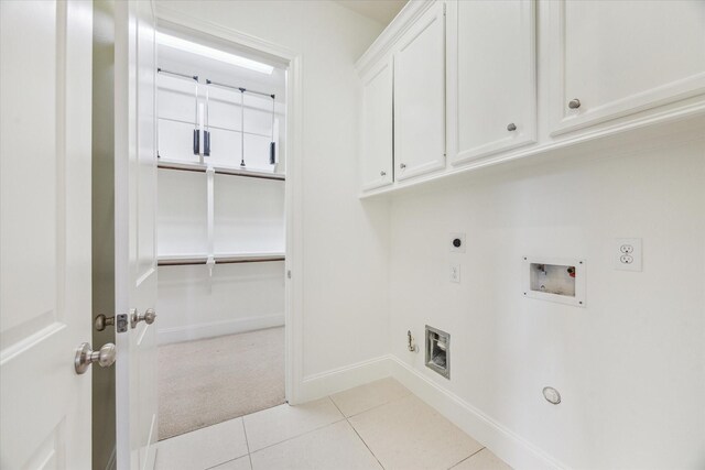 1318 Bobbitt Manor Ln, Houston, TX 77055 - washroom with hookup for a gas dryer, hookup for an electric dryer, hookup for a washing machine, cabinet space, and light tile patterned floors