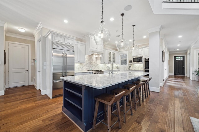 22 Hedgedale Way, Spring, TX 77389 - kitchen featuring built in appliances, ornamental molding, white cabinetry, backsplash, and open shelves