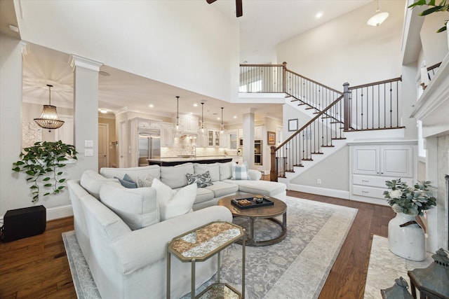 22 Hedgedale Way, Spring, TX 77389 - living room with dark wood-style floors, a high ceiling, stairway, a ceiling fan, and recessed lighting