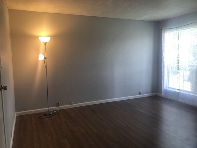 17230 Imperial Valley Dr Unit 24, Houston, TX 77060 - empty room featuring dark wood-style floors and baseboards