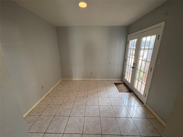17230 Imperial Valley Dr Unit 24, Houston, TX 77060 - empty room with healthy amount of natural light, french doors, and light tile patterned floors