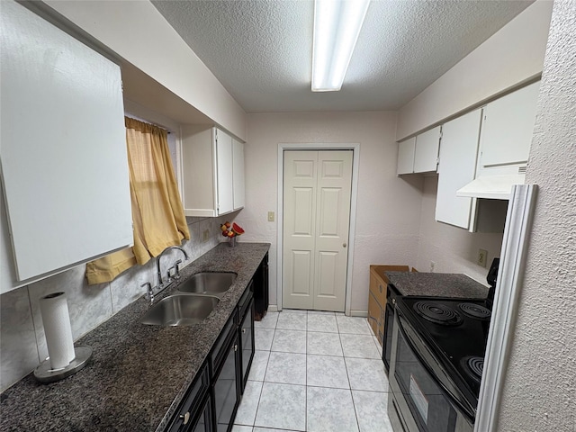 17230 Imperial Valley Dr Unit 24, Houston, TX 77060 - kitchen featuring black electric range, white cabinets, a textured ceiling, under cabinet range hood, and light tile patterned floors