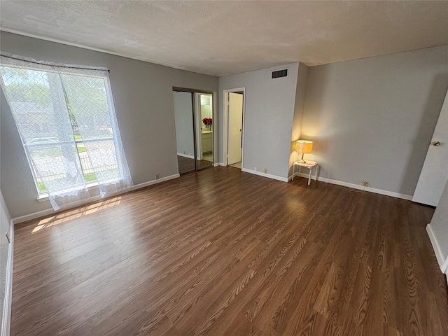 17230 Imperial Valley Dr Unit 24, Houston, TX 77060 - spare room featuring dark wood-style flooring and baseboards