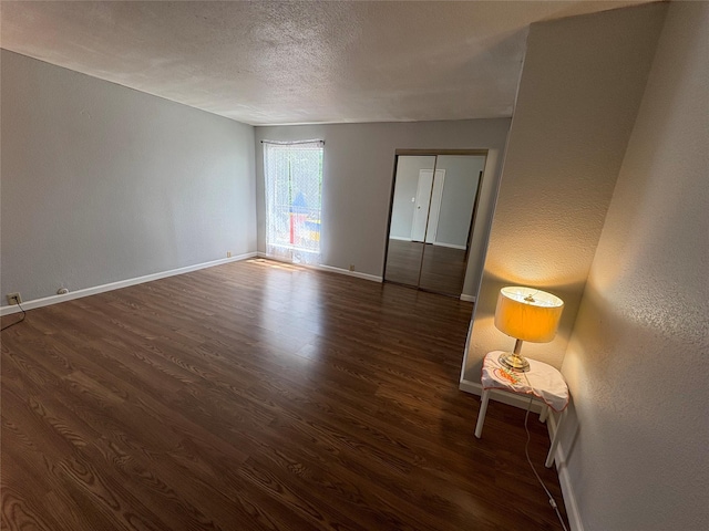 17230 Imperial Valley Dr Unit 24, Houston, TX 77060 - spare room with dark wood finished floors, a textured ceiling, and a textured wall