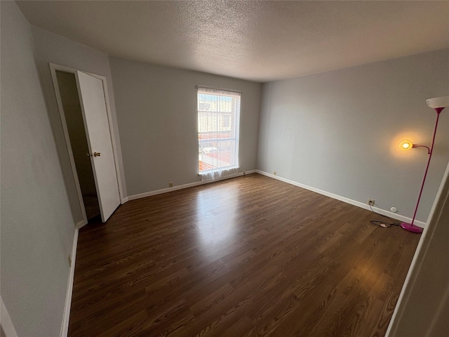 17230 Imperial Valley Dr Unit 24, Houston, TX 77060 - empty room featuring dark wood-style flooring and a textured ceiling