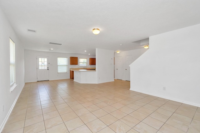 19003 Barnesdale Ct, Houston, TX 77073 - unfurnished living room featuring light tile patterned floors, baseboards, and recessed lighting