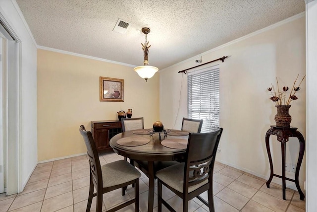 4302 Dawn Creek Ln, Spring, TX 77388 - dining area featuring light tile patterned floors, ornamental molding, a textured ceiling, and baseboards