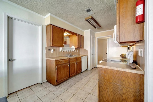 4302 Dawn Creek Ln, Spring, TX 77388 - kitchen with white dishwasher, a sink, light countertops, light tile patterned flooring, and crown molding