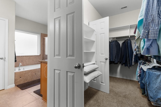6411 St Placidia Dr, Spring, TX 77379 - walk in closet featuring light tile patterned floors