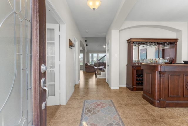 6411 St Placidia Dr, Spring, TX 77379 - foyer entrance featuring a bar, baseboards, and light tile patterned floors