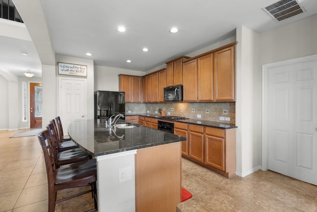 6411 St Placidia Dr, Spring, TX 77379 - kitchen with black appliances, a sink, light tile patterned floors, tasteful backsplash, and recessed lighting