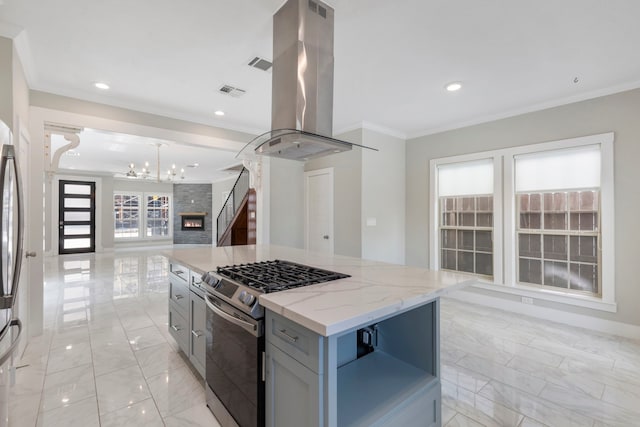 514 E 29th St, Houston, TX 77008 - kitchen featuring island exhaust hood, stainless steel appliances, open floor plan, ornamental molding, and a chandelier
