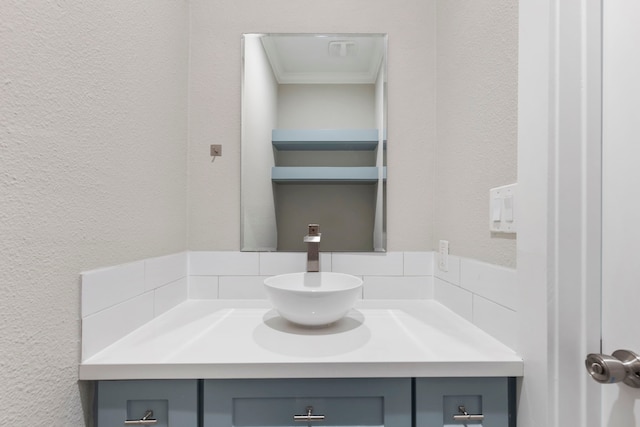 514 E 29th St, Houston, TX 77008 - bathroom featuring vanity, a textured wall, and ornamental molding