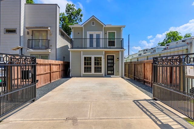 514 E 29th St, Houston, TX 77008 - rear view of house featuring a balcony, a fenced backyard, and french doors