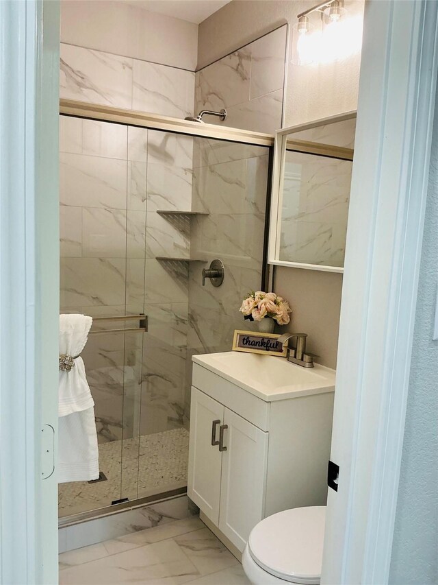 863 Dolly Wright St, Houston, TX 77088 - bathroom featuring marble look tile flooring, a marble finish shower, vanity, and toilet