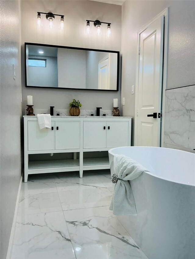 863 Dolly Wright St, Houston, TX 77088 - bathroom with marble look tiles, double vanity, a freestanding tub, and baseboards