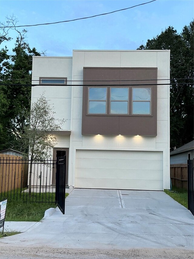 863 Dolly Wright St, Houston, TX 77088 - contemporary home featuring a garage, concrete driveway, and stucco siding