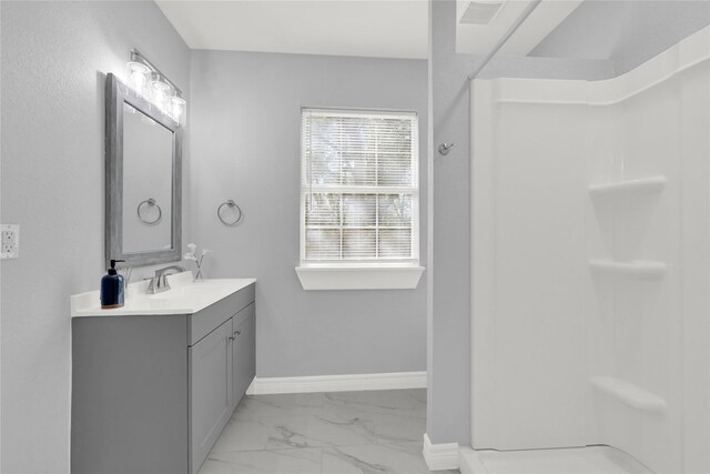 11423 Raincove Dr, Houston, TX 77016 - full bathroom with marble finish floors, vanity, a shower, and baseboards